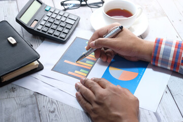 Sticker - businessman analyzing financial data at office desk 