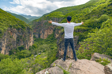 happy traveler man in rocks