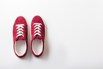 Velvet sneakers with white laces on light background