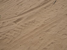 Various Tracks In The Sand - Tires From Cars, Bicycles And Human Shoes