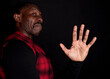 African American man, with hand up, stop racism concept, black background