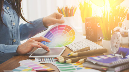 Wall Mural - Young cute Graphic designer using graphics tablet to do his work at desk