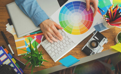 Wall Mural - Young cute Graphic designer using graphics tablet to do his work at desk view from above