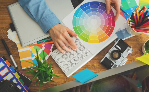 Young cute Graphic designer using graphics tablet to do his work at desk view from above