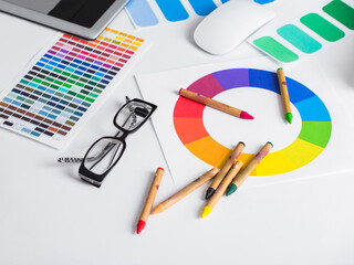 Wall Mural - color pencils, colored palette and glasses on wooden table