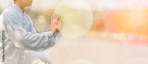 Cuadros en Lienzo Young man practicing traditional Tai Chi Chuan, Tai Ji and Qi gong in the park for healthy, traditional chinese martial arts concept