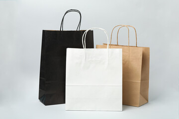  Empty paper bags on gray background, space for text.