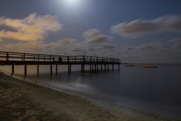 Sticker - Beautiful shot of a wooden pier on a blurred seascape background