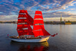 A ship with scarlet sails on the Neva. Sailboat in the center of Saint Petersburg. Sailboat on the background of the Peter and Paul fortress. Scarlet sails. A schooner with sails and a Russian flag.