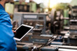 © Thirawatana - Selective focus. Professional technicians are checking the system of the machine with a tablet. Engineers and skilled technicians are maintaining machinery.