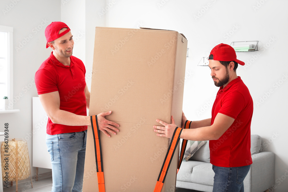 Loaders carrying big box by using cargo belts