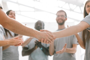 Wall Mural - close up. handshake of two students on the background of the st