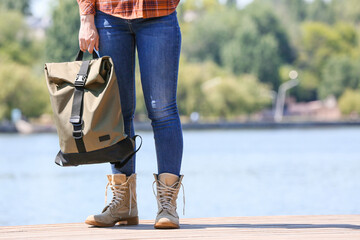 Wall Mural - Female traveler with backpack near river