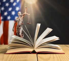 Wall Mural - old open book on a justice lady statue background