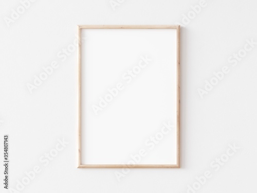 Cuadros en Lienzo Thin vertical wooden frame on white wall. 3d illustration.