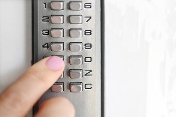 woman using a secret code to open a door