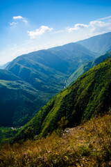 Wall Mural - Natural view of the folded mountains and lush green valleys with clear sky and clouds of Cherrapunji, Meghalaya, North East India
