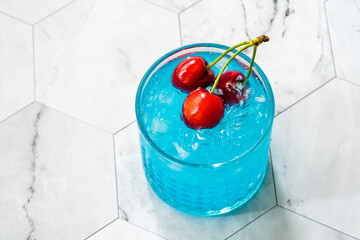 Wall Mural - Blue Lagoon Cocktail with Cherries and Crushed Ice.