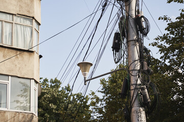 Chaos of cables and wires on an electric pole