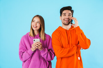 Wall Mural - Portrait of a young couple wearing hoodies