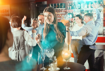 Wall Mural - Girl drinking cocktail and dancing