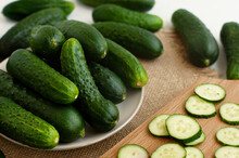 Sliced Fresh Cucumbers. Sliced Cucumbers On A Cutting Board. Cooking Cucumber Dishes. A Lot Of Fresh Cucumbers Close-up. Vegetables In A Plate On The Table.