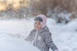 Cute child playing with snow