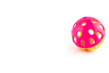 Orange and pink cat toy ball with a bell inside, isolated on a white background