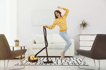 Poster - Young woman having fun while vacuuming at home