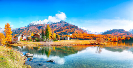 Spectacular autumn scene of Sils im Engadin (Segl) village and  Sils Lake (Silsersee).