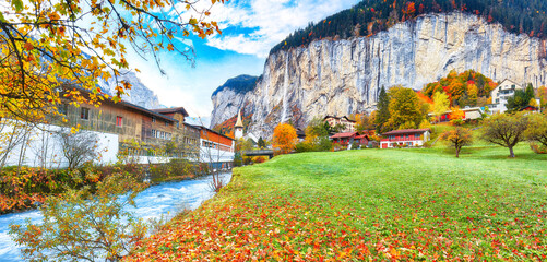 Stunning autumn view of Lauterbrunnen village with awesome waterfall  Staubbach  and Swiss Alps in the background