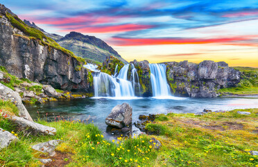 fantastic view on kirkjufellsfoss waterfall near kirkjufell mountain at sunset