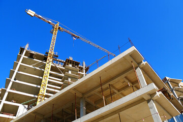 Wall Mural - Construction site background. Hoisting cranes and new multi-storey buildings. Industrial background.