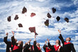 © New Africa - Happy students with diplomas throwing graduation hats in air outdoors