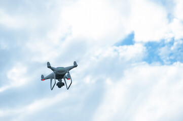 White drone with camera flying in the air