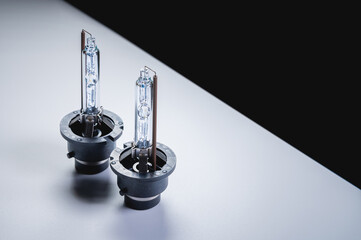 Xenon is a new two lamp for automotive headlights on a gray gradient background. Gas-discharge lighting devices