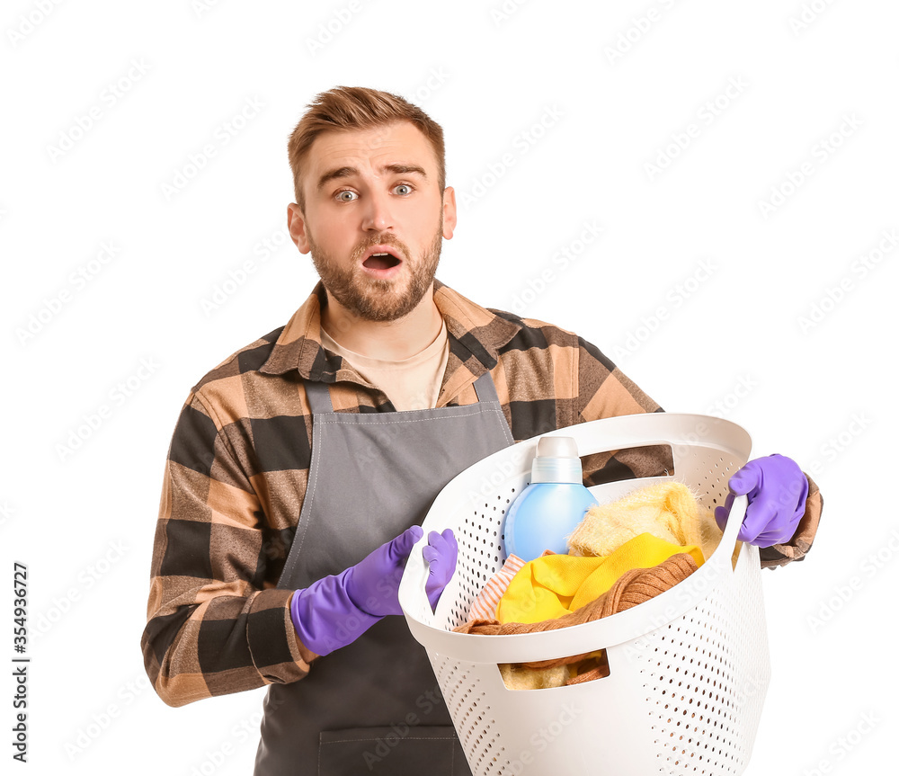 Troubled man with laundry on white background