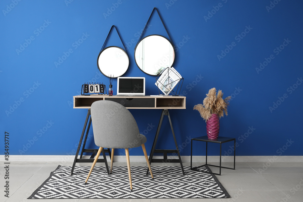 Interior of modern room with workplace and mirrors
