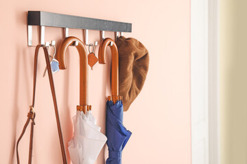 Stylish umbrellas hanging on wall in interior of hall