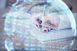 © peshkova - International business hologram over hands taking notes background. Concept of success. Multi exposure
