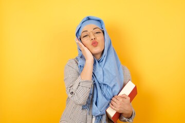 Sticker - Leisure lifestyle celebrate flirt coquettish concept. Beautiful gorgeous young muslim woman wearing hijab, making v-sign near eyes wearing casual clothes standing against gray wall.