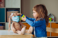 Toddler Girl Playing Doctor Giving An Injection Bunny Toy