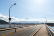 Bridge road over Kawaguchiko lake with Mountain Fuji at the background