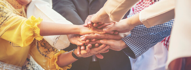 Group of people diversity multiethnic teamwork collaboration team meeting communication  Unified team concept. Business people hands together diversity multiethnic diverse culture partner team meeting