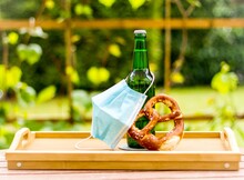 Green Beer Bottle With Pretzel And Face Mask