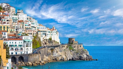 Wall Mural - Beautiful Amalfi with hotels on hills leading down to coast, comfortable beaches and azure sea in Campania, Italy.