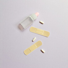 Band Aid And Pills On Purple Background. Medical Concept. Simple, Minimal