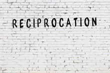 Word Reciprocation Painted On White Brick Wall