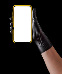 Wall Mural - Hand in black glove holding mobile phone with blank screen isolated on black