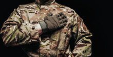 Soldier In Camouflaged Tunic With Hand On A Heart , Torso View.